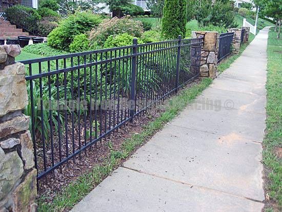 custom iron fencing installed in the garden near pathway