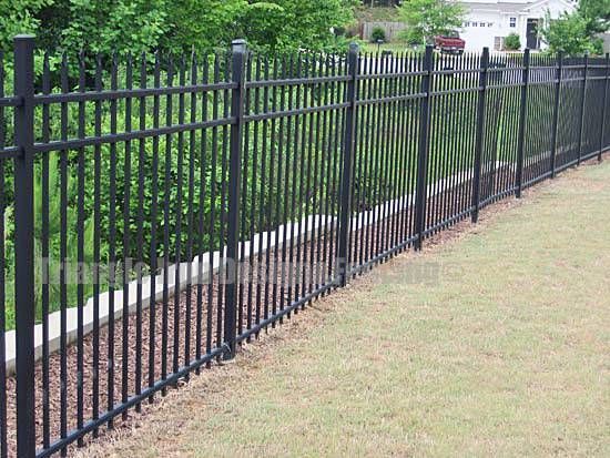 wrought iron fencing installed at the road near garden 