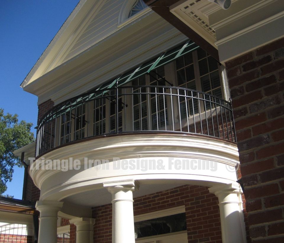 distant view of the round shaped custom iron railing at the balcony
