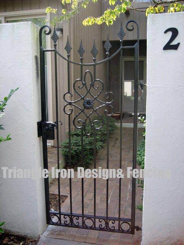 handmade iron made door panel installed in the gate outside house