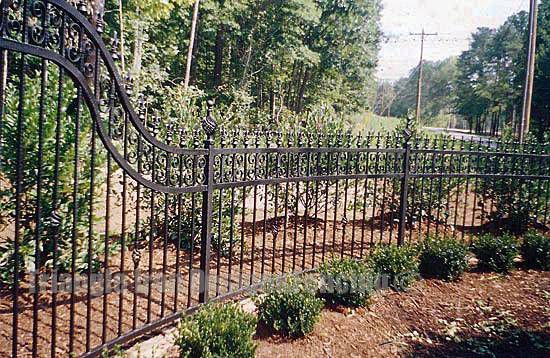 custom iron fencing installed at the pathway near road
