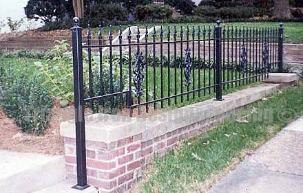 iron fencing installed in the wall near road