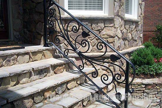 custom iron railing at the stairs outside house