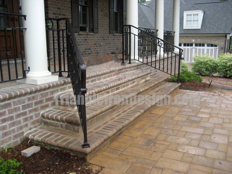 custom iron railings at the stairs near pillars outside house