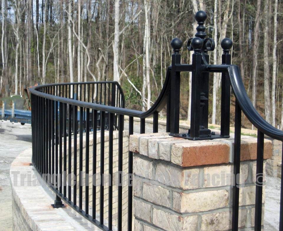 closeup view of the custom iron fencing near road 